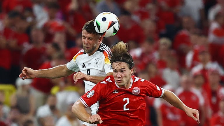 Pemain Timnas Jerman dan Denmark berduel di udara memperebutkan bola dalam laga babak 16 besar Piala Eropa 2024. Dalam laga tersebut Jerman menang 2-0. Foto:Reuters